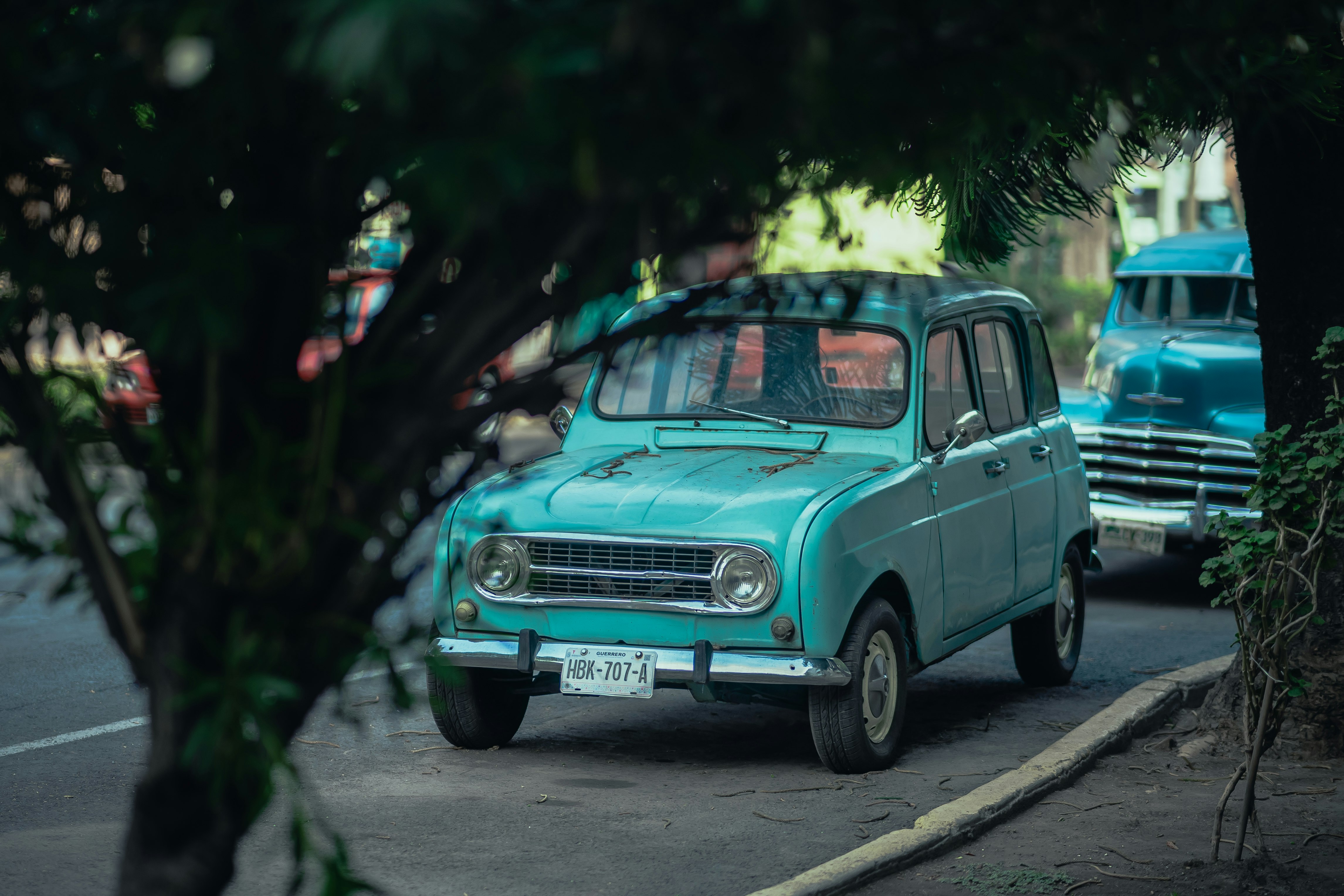 teal car parked on the street